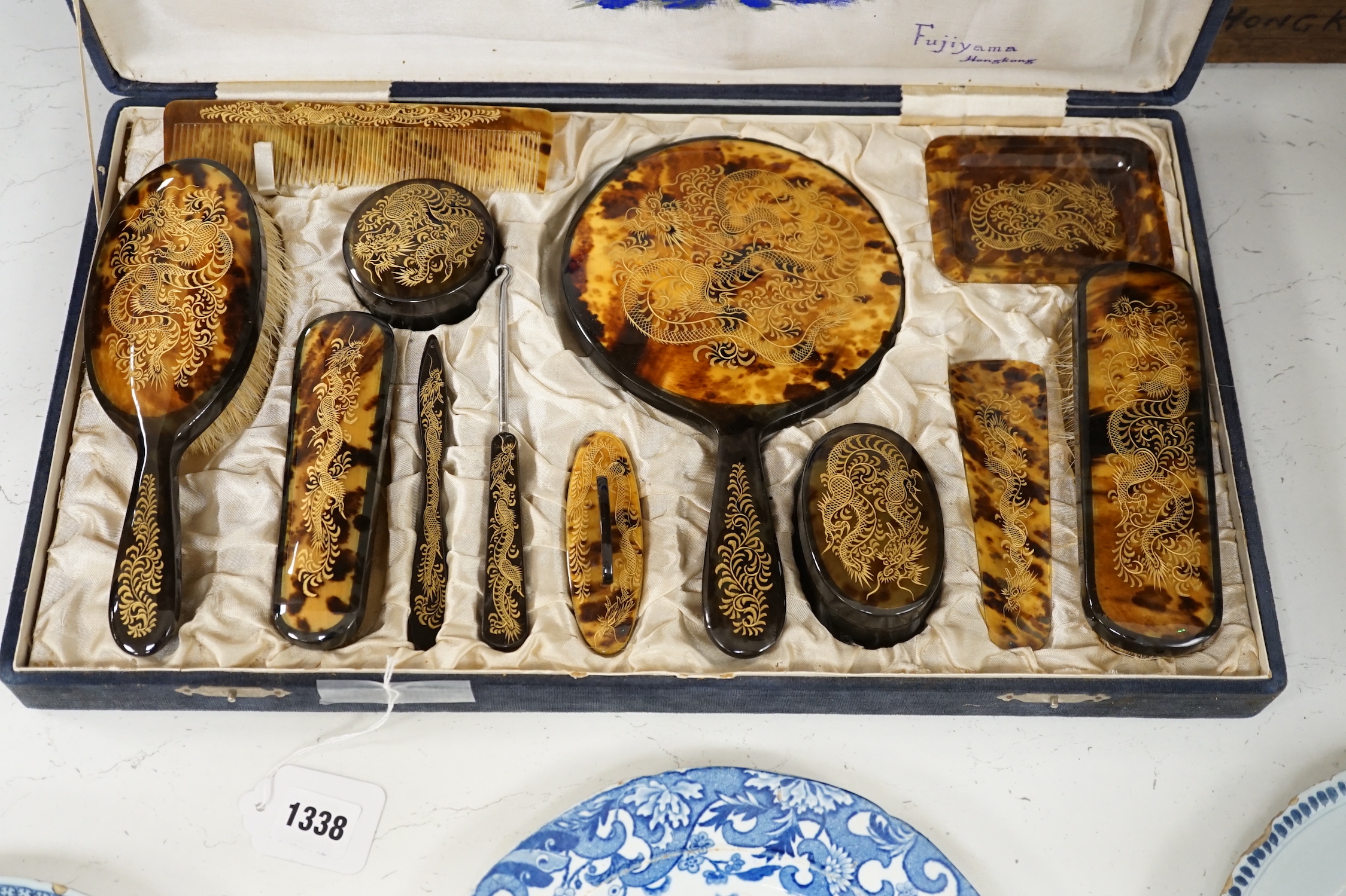 A cased Japanese tortoiseshell dragon decorated dressing table set, c.1940 (with original packing case sent from Hong Kong in 1940)